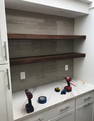 floating shelf installation in kitchen