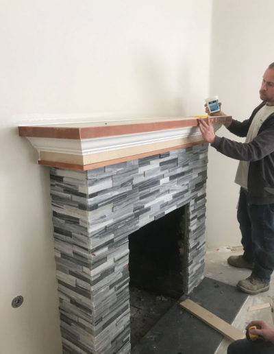 finishing up building the custom stacked stone fireplace