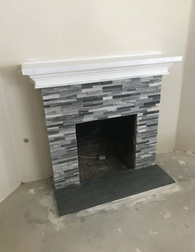 stacked stone fireplace, grey, black, and white