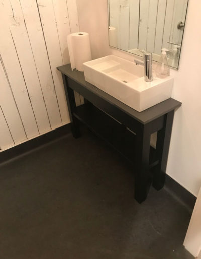 rectangular vessel sink in industrial bathroom
