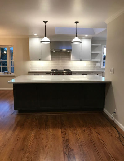 dark long counter island with pendant lighting