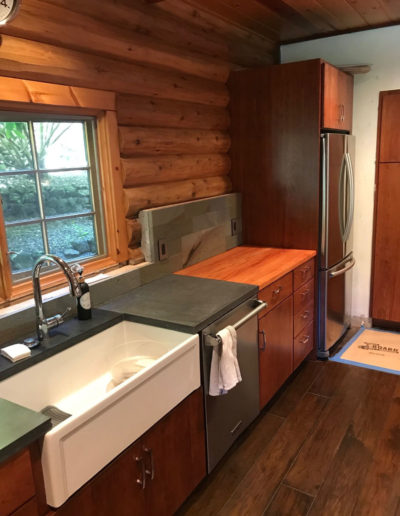 white apron sink in log cabin kitchen