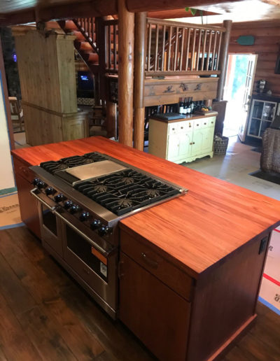 large stove in log cabin kitchen remodel