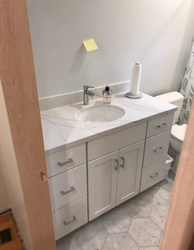 white and grey bathroom with hexagon tile