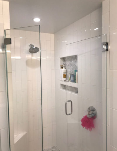 glass shower with vertical white tile