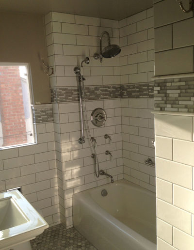 Shower in white tile bathroom - remodel in the Bay Area