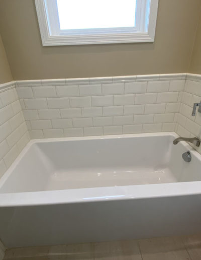bathtub with white tile