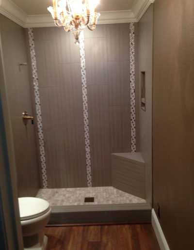 grey shower with vertical tile striping