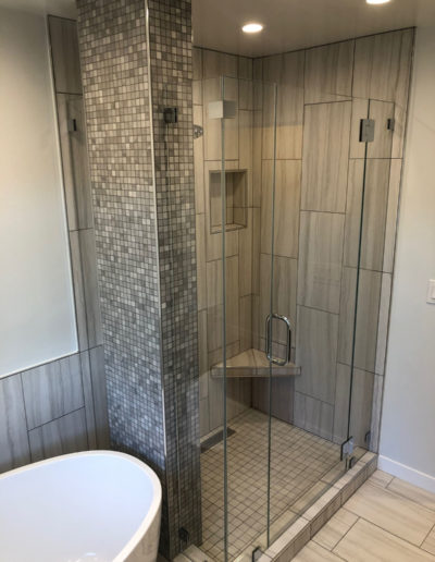 new shower with glass door and tile